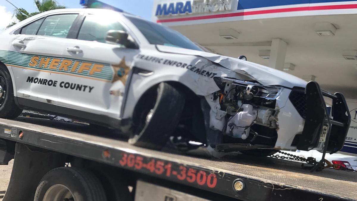 A damaged Monroe County Sheriff’s Office patrol car is on top of a flatbed tow truck in front of a Key Largo gas station Tuesday, Nov. 6. The crash sent a deputy to the hospital to be treated for minor injuries.