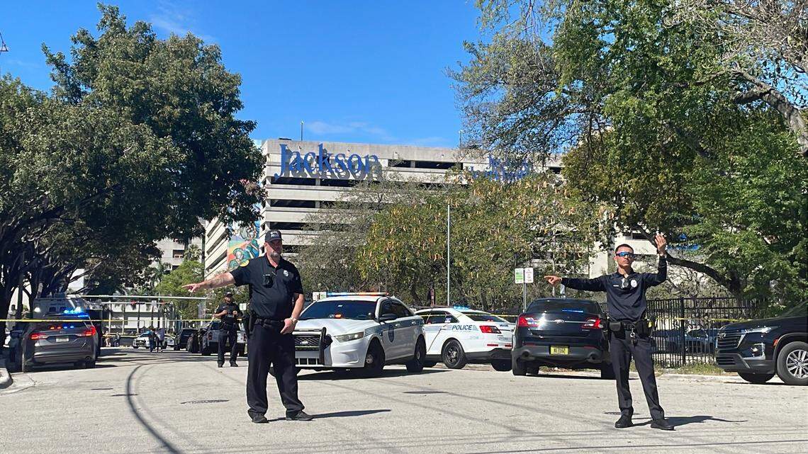 Miami police officers direct traffic at Northwest 17th Street and Eight Avenue after authorities said a cop shot an armed man on Friday, Feb. 23, 2024.