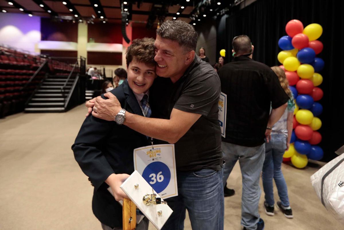 Miami Herald Broward Spelling Bee Winner Brody Santos, 12, a seventh grader at St. Mark’s Episcopal School in Fort Lauderdale, gets a hug from his father Anderson Santos at the Charles F. Dodge City Center, Pembroke Pines, on Thursday. Brody will compete in the 2022 Scripps National Spelling Bee at the end of May-beginning of June.