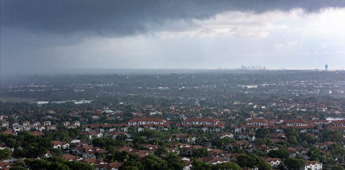 Rain makes its way over a neighborhood on Monday, July 14, 2025, in Pembroke Pines, Fla.
