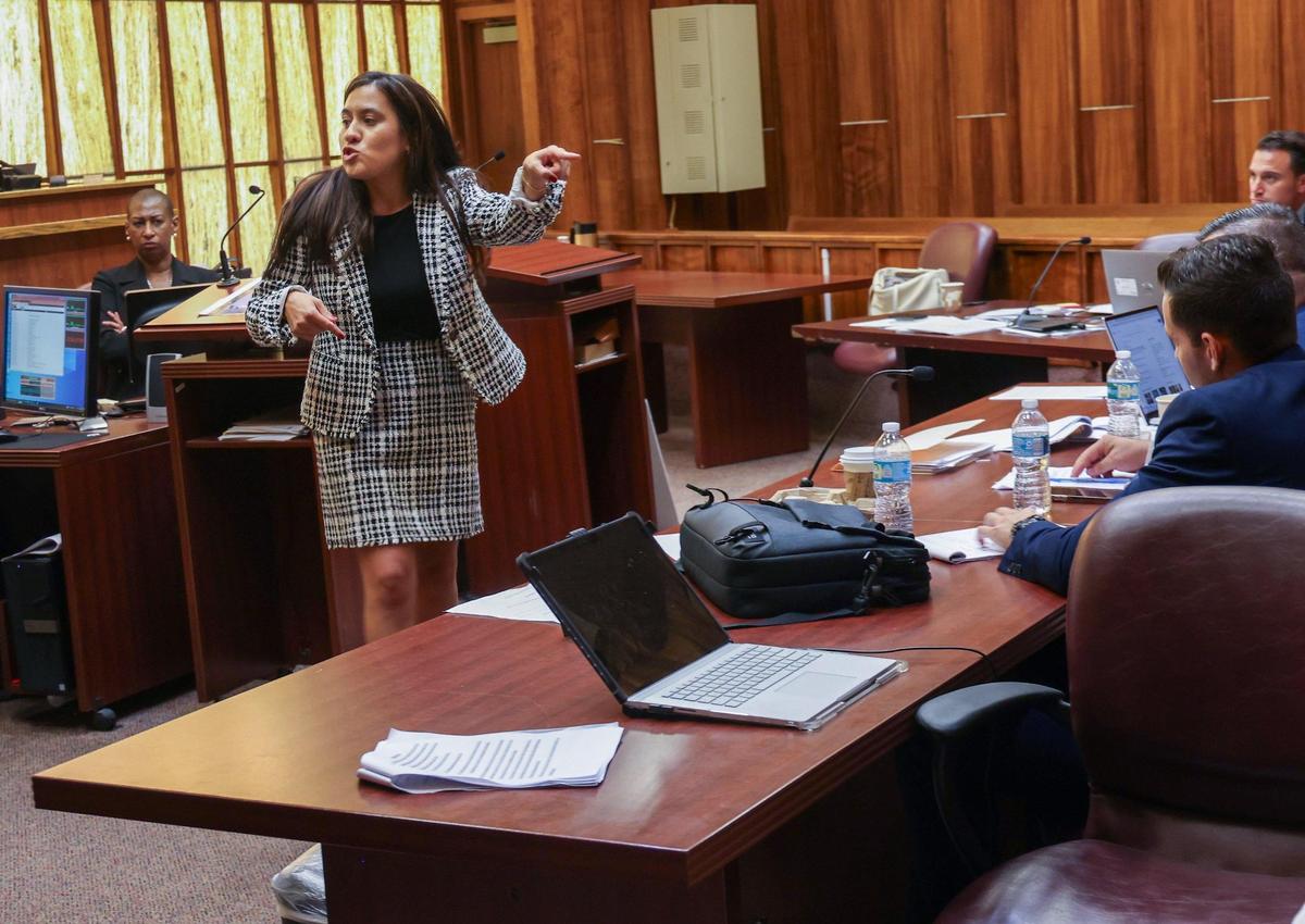 State attorney Carolina Sanchez, left, points to Rafael Otano, right, as she delivers a rebuttal to the closing statements of the defense attorne for the former Hialeah police officer. Otano and other Hialeah officer have been charged with beating a homeless man..