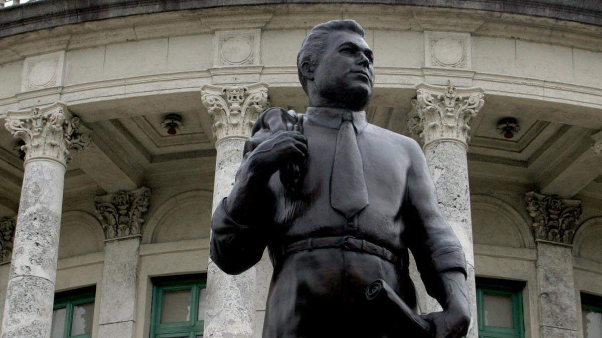 A statue of Coral Gables founder George Merrick stands in front of Coral Gables City Hall.