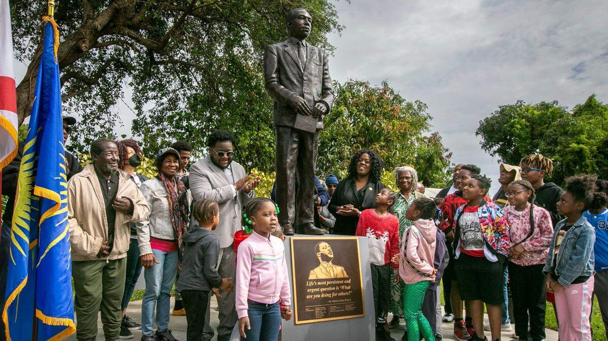 North Miami Beach elected officials and residents of the Washington Park neighborhood in North Miami Beach gaze up at the newly unveiled statue of Dr. Martin Luther King on March 20, 2023, at MLK Linear Park on 15th Court and NE 153rd Terrace.