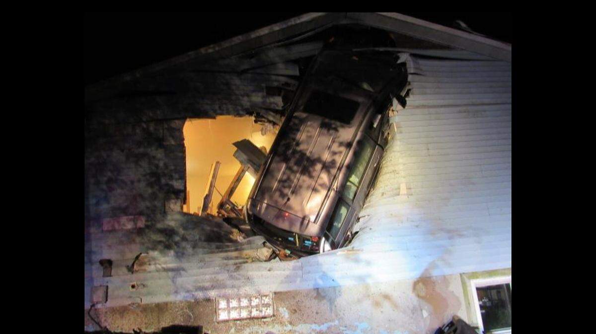 Authorities say a minivan went airborne and got stuck in the side of a Newburg, Wisconsin home.