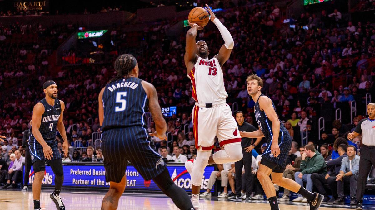 Miami Heat center Bam Adebayo (13) shoots over Orlando Magic Pablo Banchero (5) during the first half of an NBA game on Wednesday, October 23, 2024, in Miami, Fla.
