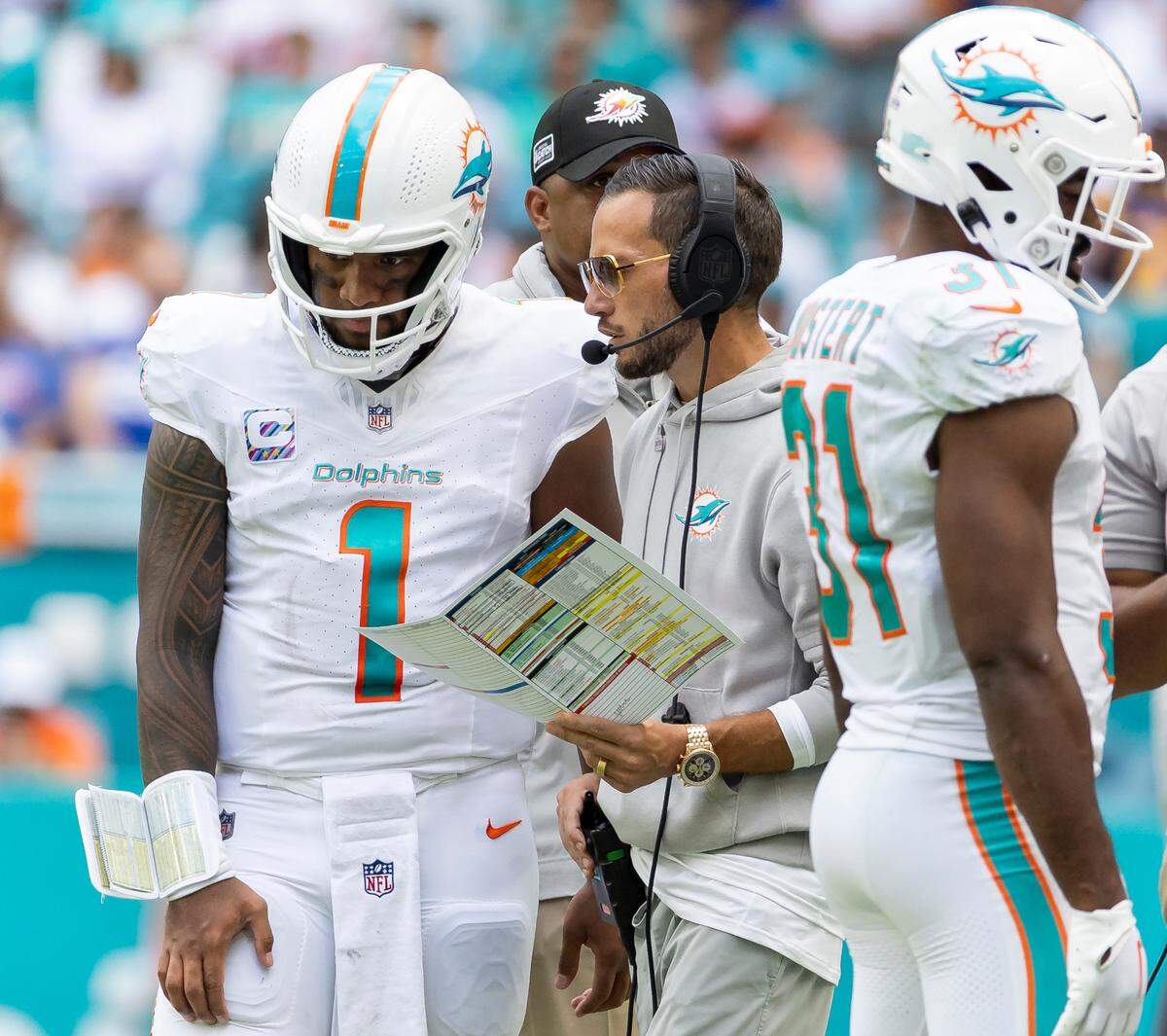 Miami Dolphins quarterback Tua Tagovailoa (1) talks to head coach Mike McDaniel in the second quarter of their NFL game against the New York Giants at Hard Rock Stadium on Sunday, Oct. 8, 2023, in Miami Gardens, Fla.