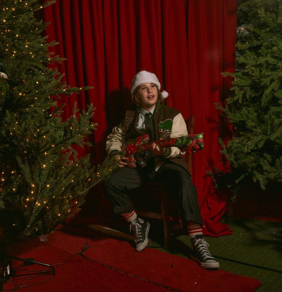 Sasha Estefan-Coppola, 10, gets into the Christmas spirit at a photo session at Miami’s The Christmas Palace produced by his mom, Lara Estefan-Coppola in the summer of 2022.
