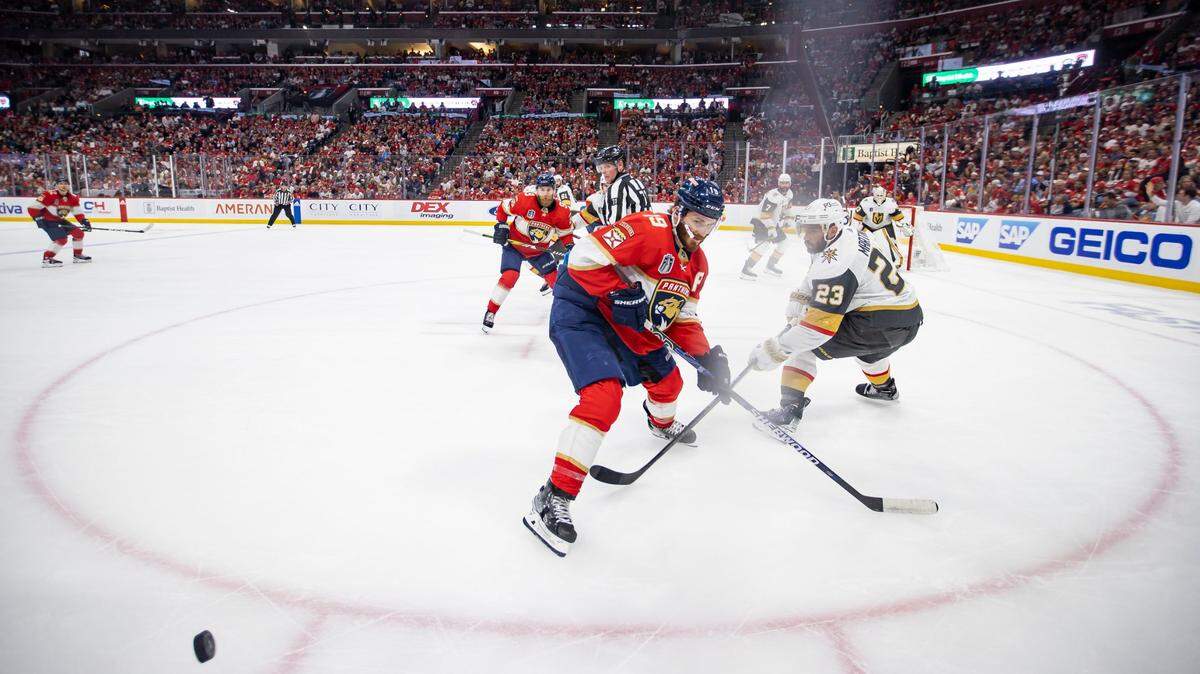 Florida Panthers left wing Matthew Tkachuk (19) and Vegas Golden Knights defenseman Alec Martinez (23) compete for the puck in the first period of Game 4 of the NHL Stanley Cup Final at the FLA Live Arena on Saturday, June 10, 2023, in Sunrise, Fla.