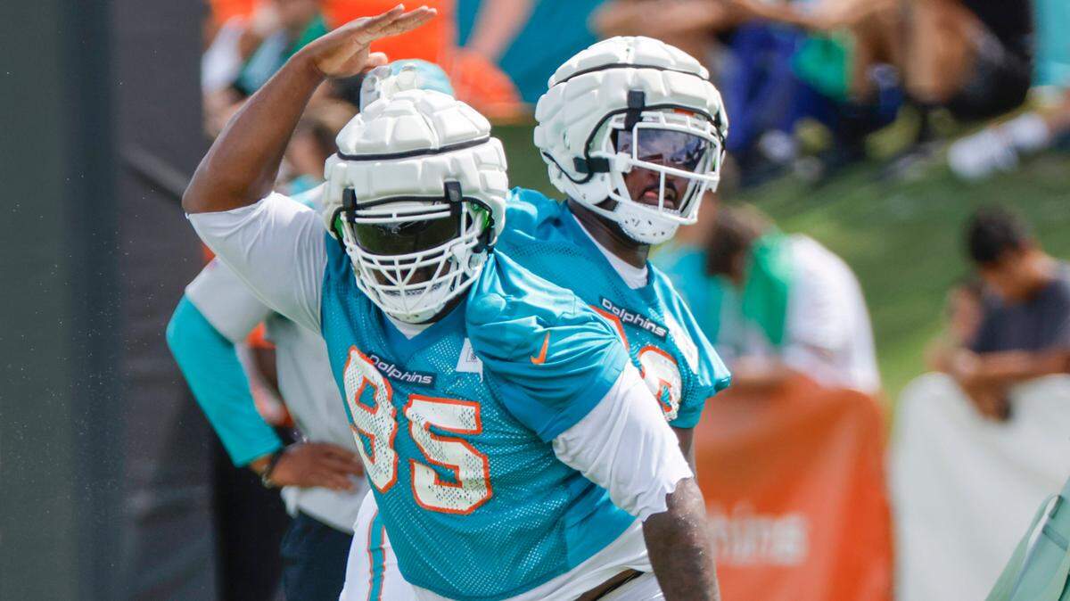 Miami Dolphins defensive tackle Benito Jones (95) and Mario Kendricks (68) run through practice drills with at the Baptist Health Training Complex in Miami Gardens on Saturday, July 28, 2024.