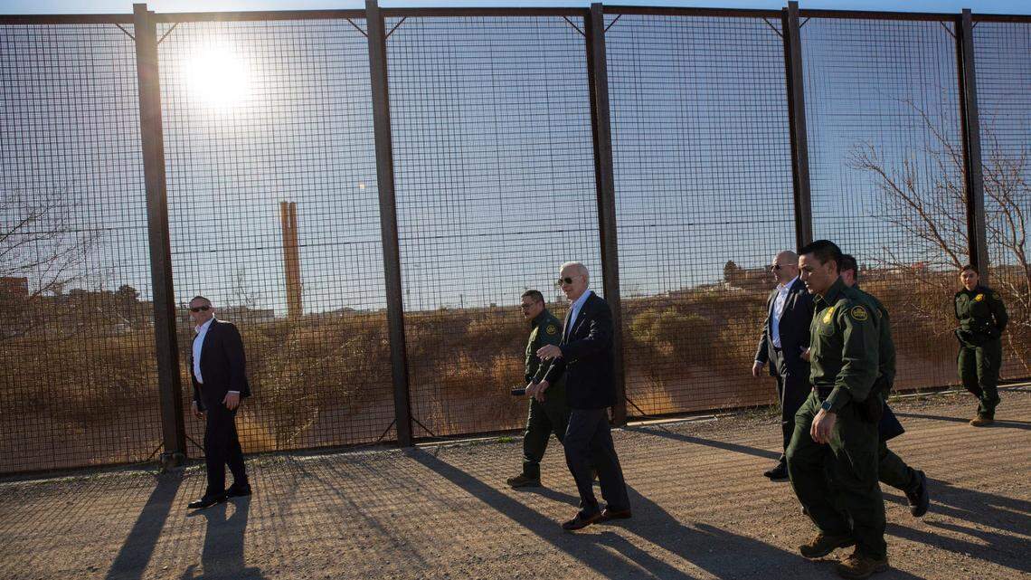 President Joe Biden walks along the border fence with Border Patrol agents on Jan. 8, 2023.