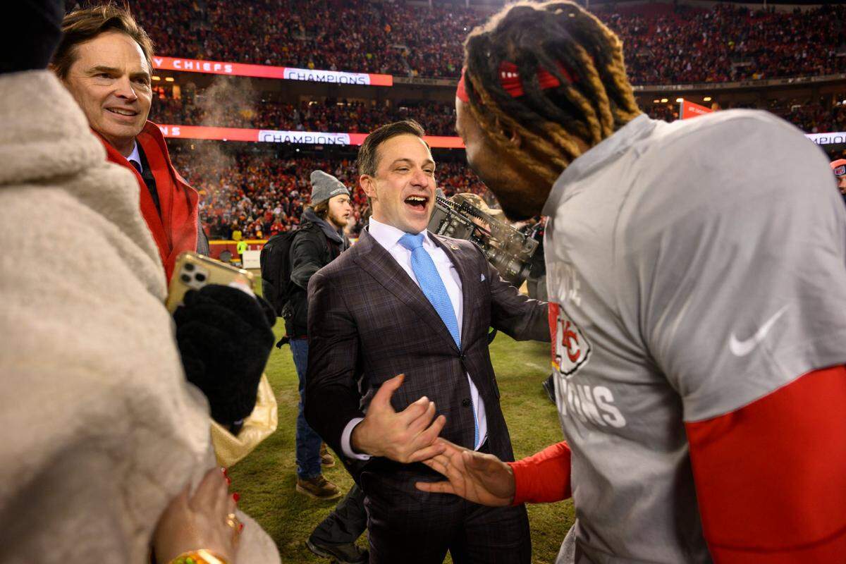Kansas City Chiefs General Manager Brett Veach, center, celebrates with Chiefs safety Justin Reid, right, as Chiefs President Mark Donovan, left, looks on after they beat the Cincinnati Bengals in the NFL AFC Championship playoff football game, Sunday, Jan. 29, 2023 in Kansas City, Mo. (AP Photo/Reed Hoffmann)