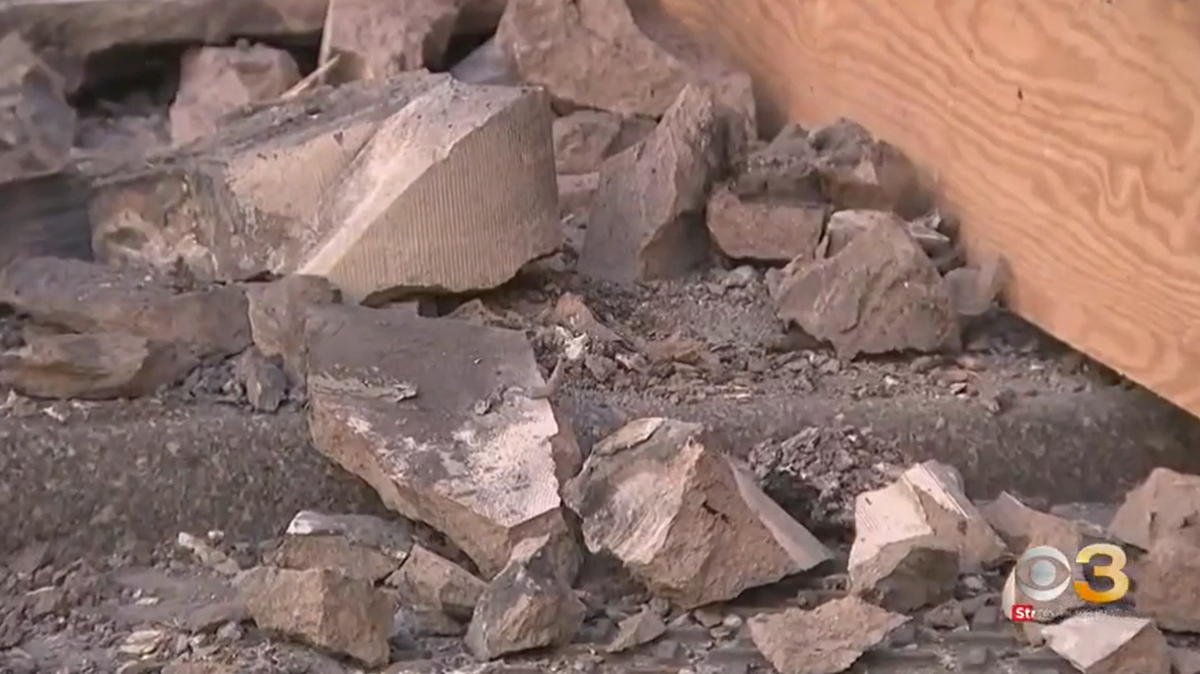 Concrete debris covered a Philadelphia sidewalk after a 30-year-old woman was struck in the head by a falling piece, reports say.