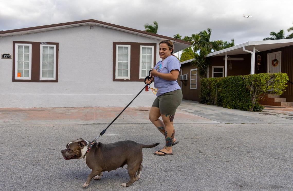 Yessy D., who asked her last name be omitted, walks her dog, Mia, at Li’l Abner Mobile Home Park, where she and others face displacement, on Thursday, Nov. 14, 2024, in Sweetwater, Florida.