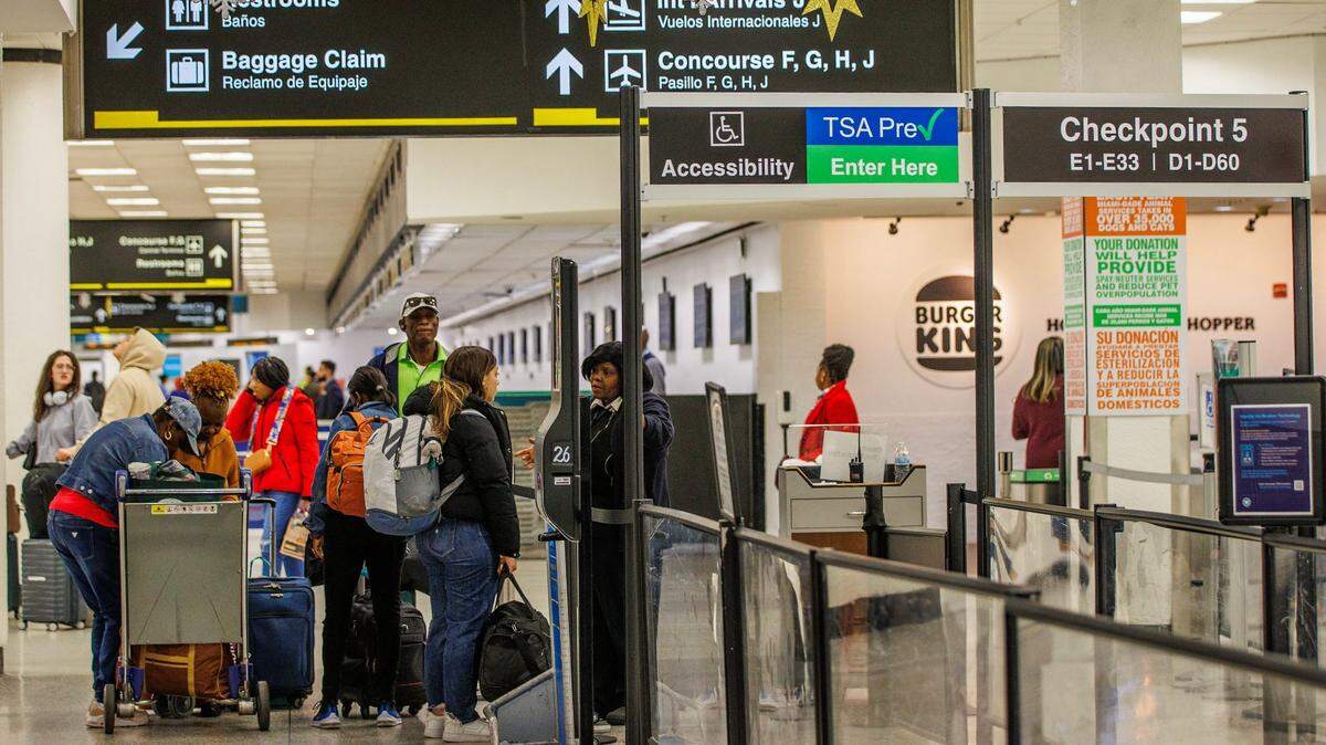 Travelers enter TSA checkpoint 5 at the Miami airport.