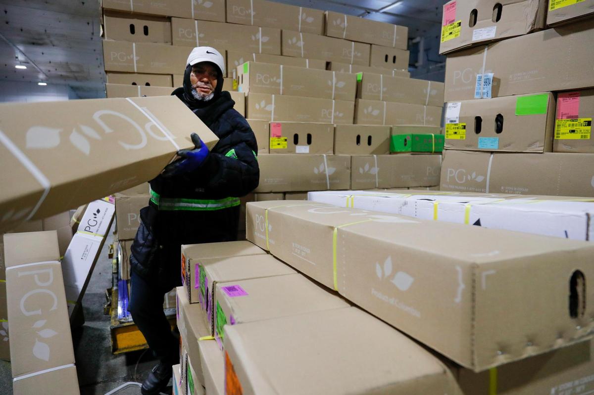 An Avianca Cargo employee arranges boxes with flowers arriving from Colombia and Ecuador at Miami International Airport on Monday, Feb. 6, 2023.
