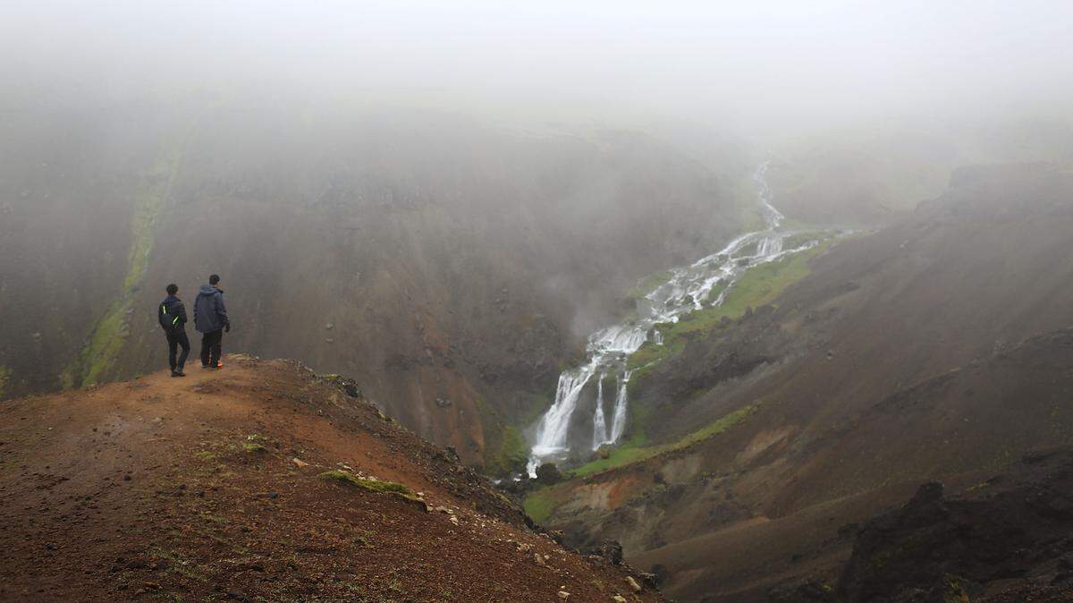 Visitors enjoy the views on a hike to the Hveragerdi hot spring river on June 5, 2017 in Hveragerdi, Iceland.