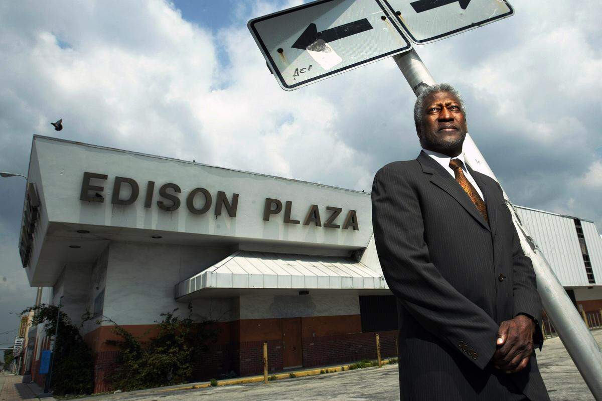 In this file photo from May 12, 2005, Otis Pitts Jr. stands before the Edison Plaza area of Miami, an area he helped revitalize by bringing in a new mall to the area.