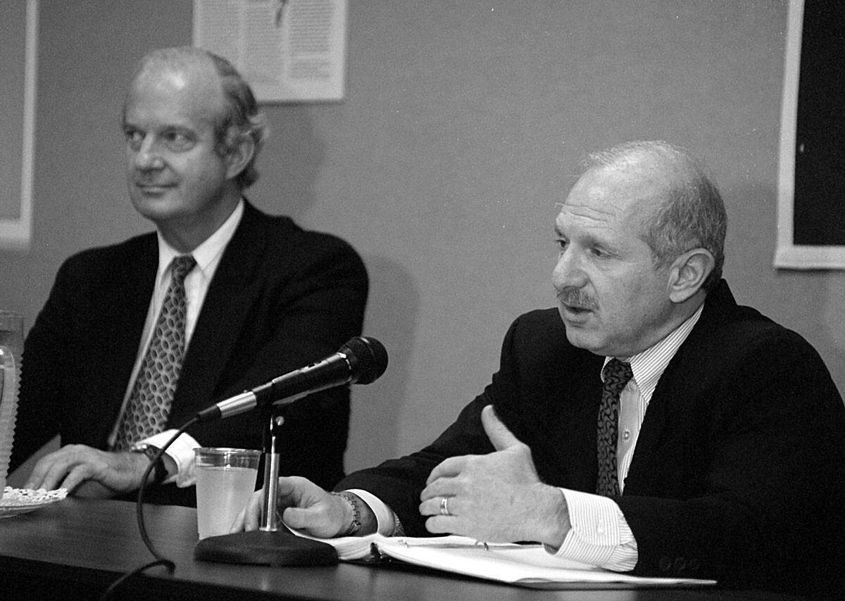 In this file photo from Dec. 5, 1995, Mark Schneiderl, right, of the United States Information Agency, discusses diplomacy with University of Miami international studies professor Ambler Moss at the North-South Center at UM. Moss was a U.S. ambassador to Panama during the Carter and Reagan administrations.
