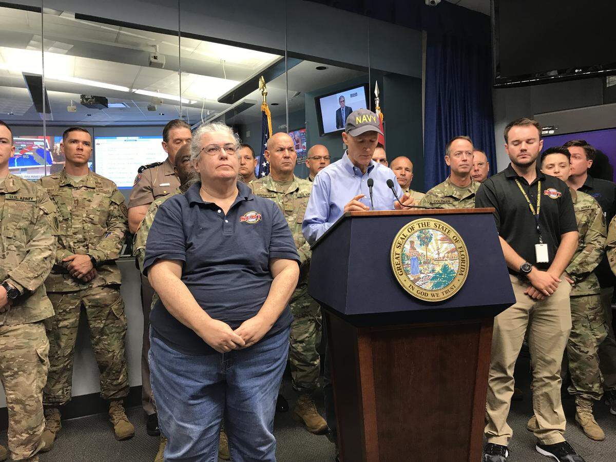 Gov. Rick Scott, flanked by state emergency management chief Wes Maul and several other officials, speaks during a press briefing ahead of Hurricane Michael Wednesday.
