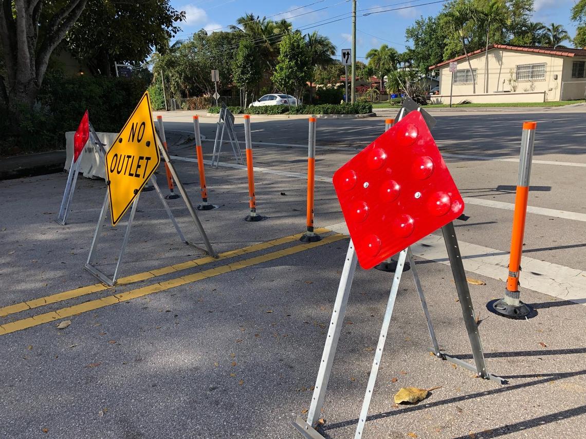 Temporary closure signs that Miami put up on Southwest 23rd Street by Southwest 17th Avenue on March 2, 2021. Miami-Dade ordered the city to remove the signs, and the city refused.