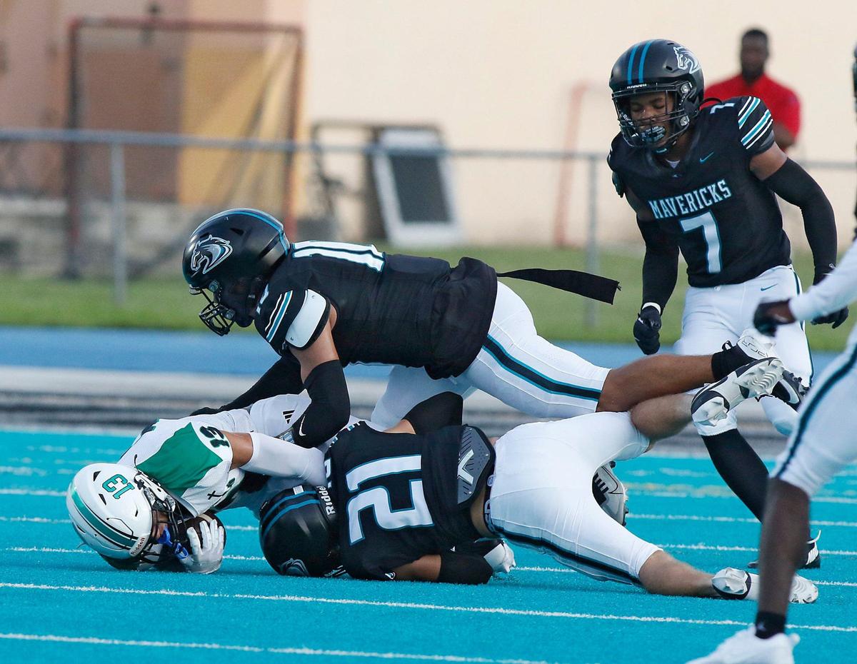 Archbishop McCarthy Mavericks defenders take down St. Brendan Sabres wide receiver Nick Castro (13) during football game on Thursday, September 5, 2024 at Archbishop McCarthy HS in Southwest Ranches. Andrew Uloza / for Miami Herald