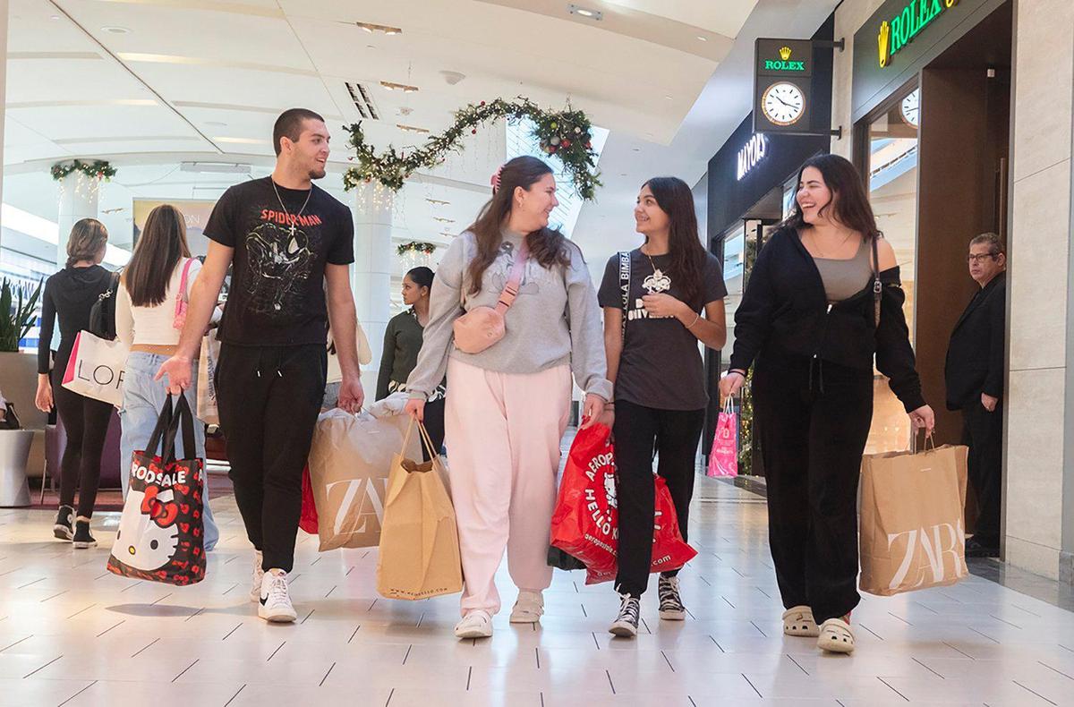 Black Friday doorbusterse (L to R) Matthew Costa, Melanie Costa, Stephanie Sanchez and Cassandra Sanchez, shop during Black Friday at Dadeland Mall on Nov. 29, 2024.