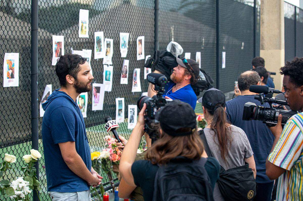 Leo Soto, 26, a former high school classmate of missing person, Nicky Langesfeld, speaks with the media about how he erected a make-shift memorial for people to gather and pray at, for the missing people near the site of the partially collapsed Champlain Towers South Condo in the Surfside community of Miami Beach, Florida, on Friday, June 25, 2021. The 12-story oceanfront condo tower at 8777 Collins Ave. crumpled just after 1:30 a.m., on Thursday June 24, trapping an unknown number of residents asleep in their beds inside the wreckage.