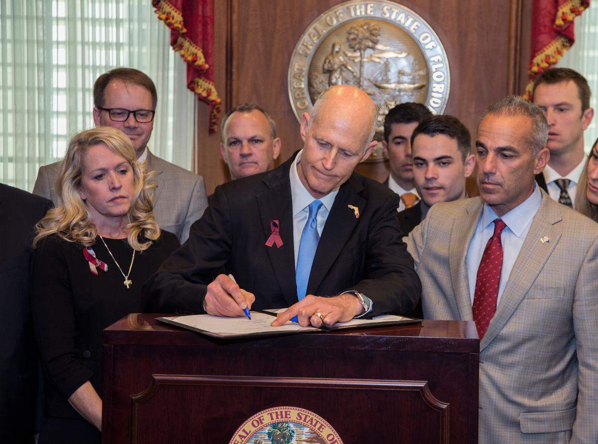 Flanked by Parkland parents and students, Florida Gov. Rick Scott signed a gun-safety measure championed by students from Marjory Stoneman Douglas High in March. The act requires a safe-school officer in every school and provided $67 million to school districts to use that money to train and arm school personnel who weren’t classroom teachers. Many school districts, however, were averse to arming non-sworn employees and preferred using sworn law enforcement officers instead, asking state officials to redirect that funding.
