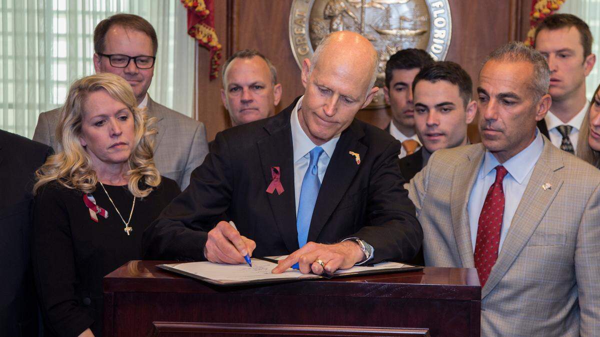Flanked by Parkland parents and students, Florida Gov. Rick Scott signed a gun-safety measure championed by students from Marjory Stoneman Douglas High in March. The act requires a safe-school officer in every school and provided $67 million to school districts to use that money to train and arm school personnel who weren’t classroom teachers. Many school districts, however, were averse to arming non-sworn employees and preferred using sworn law enforcement officers instead, asking state officials to redirect that funding.