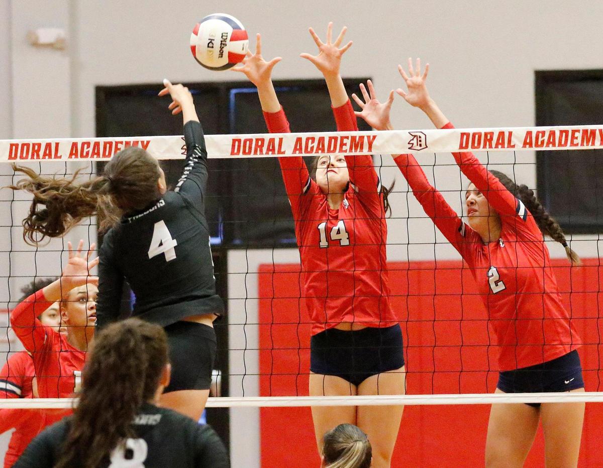 Doral Academy Firebirds Erin McMullen (14) and Ainhoa Molleja (2) goes for a double block during volleyball game against Ferguson Falcons on Saturday, October 29, 2022 at Doral Academy in Doral. Andrew Uloza / for Miami Herald