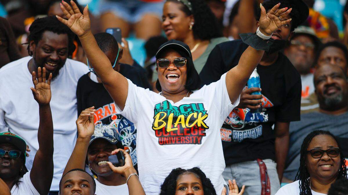 A football fan wearing a HBCU t-shirt cheers from the stands during the Orange Blossom Classic game between the Jackson State Tigers and the Florida A&M Rattlers at Hard Rock Stadium in Miami Gardens, Florida, Sunday, September 4, 2022. The 2024 iteration of the OBC will pit the Alabama State University Hornets against the North Carolina Central Eagles.