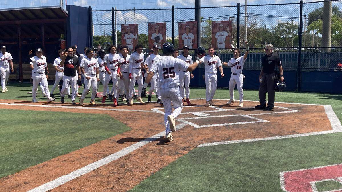 Southridge’s Jonathan Paniagua is greeted at the plate by his teammates following his walk-off grand slam in the bottom of the fifth of the decisive game of the Region 4-6A semifinal Saturday at Doral Academy.