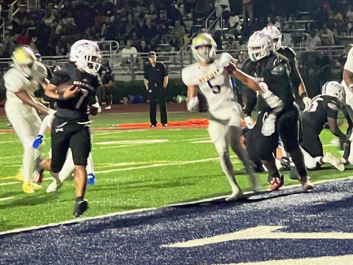 Chaminade senior running back Davion Gause, who rushed for 158 yards on 10 carries with three touchdowns, scores his first of the night on a two-yard run in the first quarter of Friday’s 40-0 win over Cardinal Newman in the Region 3-1M final.