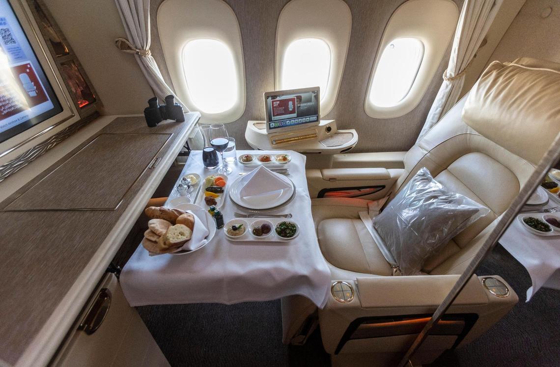First class seating set up for dining, inside the Boeing 777-300ER operated by Emirates.
