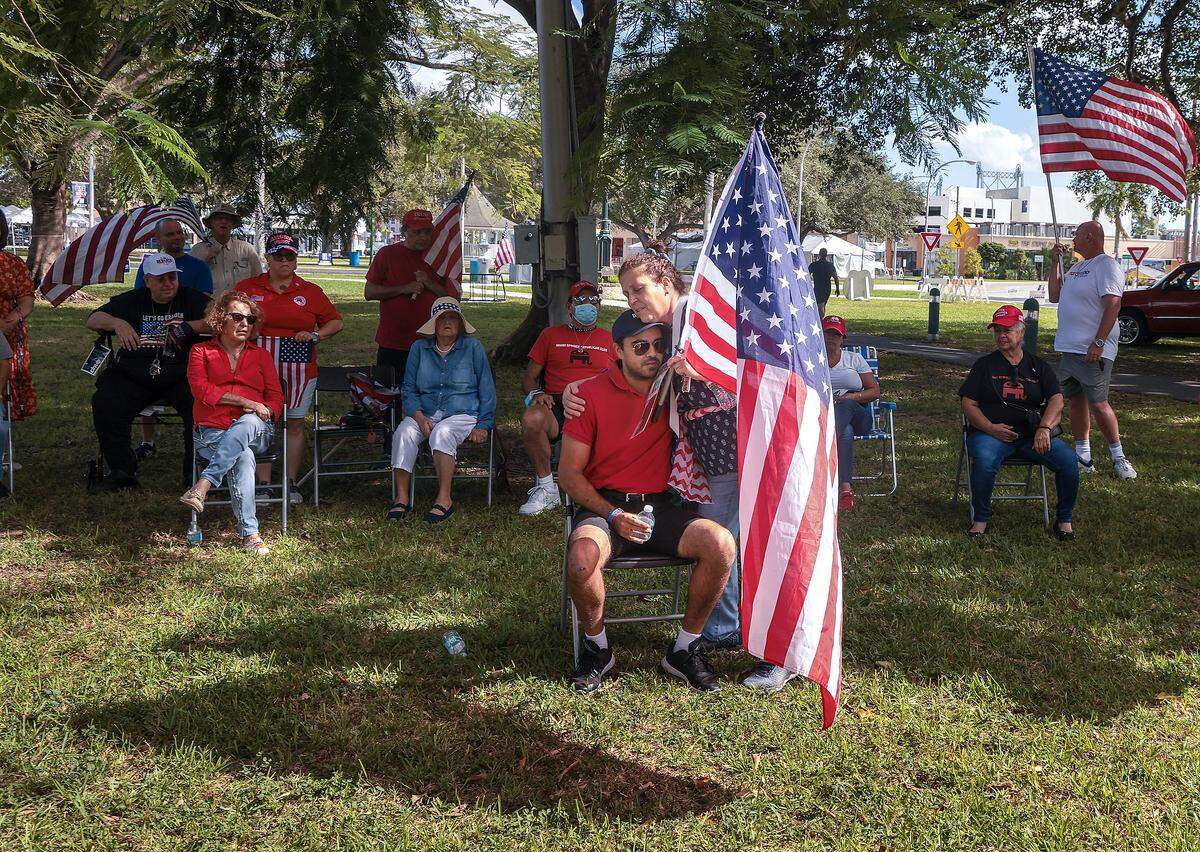 Hialeah resident Mayra Jimenez hugs Christopher Monzon, who addressed a small crowd of supporters at the Miami Springs Circle Park on Sunday, Oct. 30, 2022.