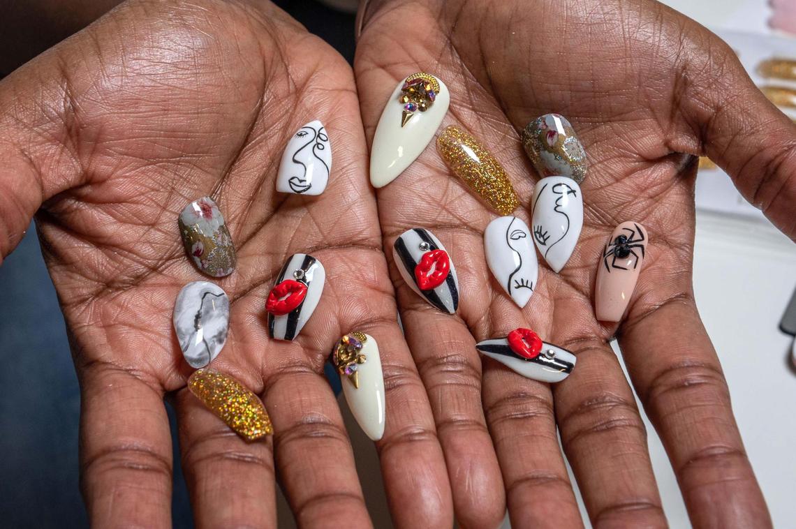 Aurelia Edwards, founder of Nailstry, shows an array of press-on nails in artistic designs, at her office in Fort Lauderdale on April 20, 2022.