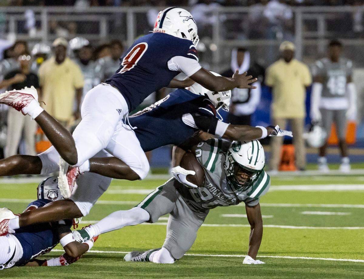 Central Rockets running back Jayden Ford (20) runs with the ball as Chaminade-Madonna Lions defensive back Zaquan Patterson (0) tries to tackle him in the second quarter of their high school football game at the Nathaniel Traz Powell Stadium on Thursday, Sept. 21, 2023, in Miami, Fla.
