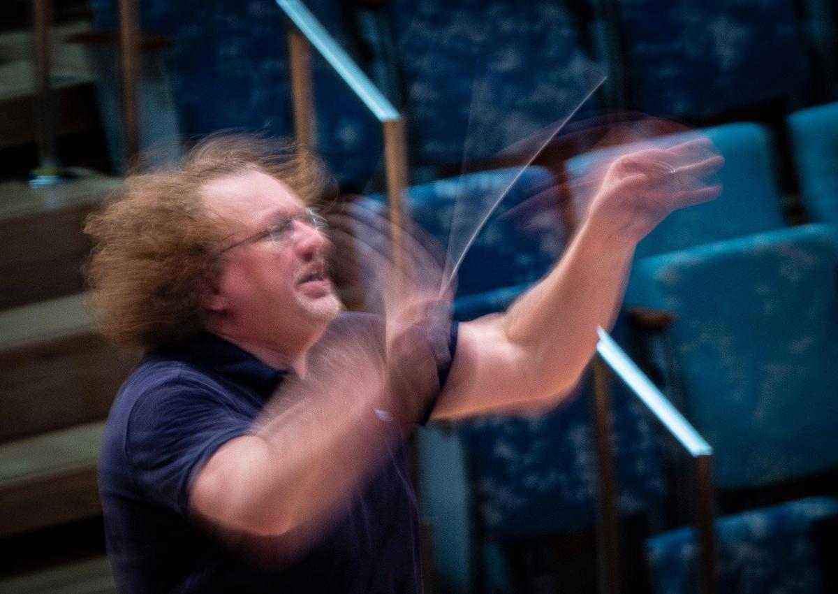 Stéphane Denève, artistic director, conducts the orchestra playing a Claude Debussy piece during a New World Symphony rehearsal on Thursday, Sept. 14, 2023, at the New World Center in Miami Beach. Denève asked the violins to play more “Halloweeny” because “I like to use different sensations to direct the sound I want.”