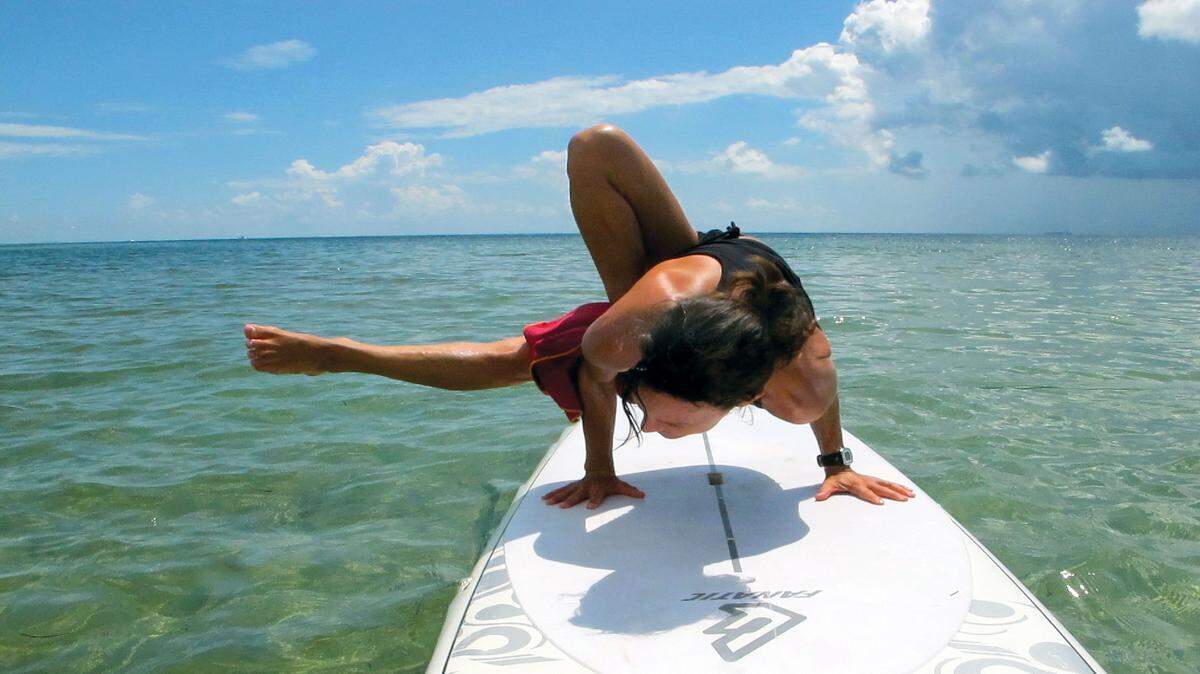 The Dharmi Insitute stand-up paddleboard yoga session on the bay