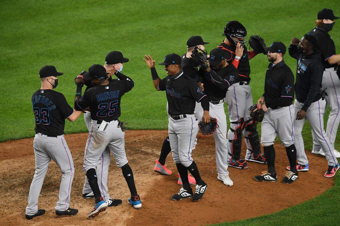 NEW YORK, NEW YORK - SEPTEMBER 25: The Miami Marlins celebrate during the tenth inning against the New York Yankees at Yankee Stadium on September 25, 2020 in the Bronx borough of New York City. The Marlins won 4-3 and clinched a playoff berth. (Photo by Sarah Stier/Getty Images)