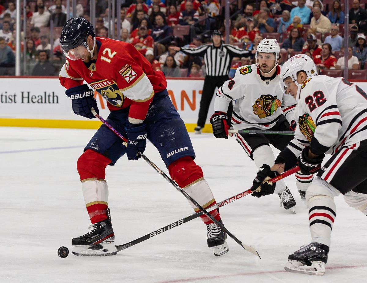 Florida Panthers center Eric Staal (12) holds possession of the puck against Chicago Blackhawks defenseman Nikita Zaitsev (22) during the first period of an NHL game at the FLA Live Arena on Friday, March 10, 2023, in Sunrise, Fla.