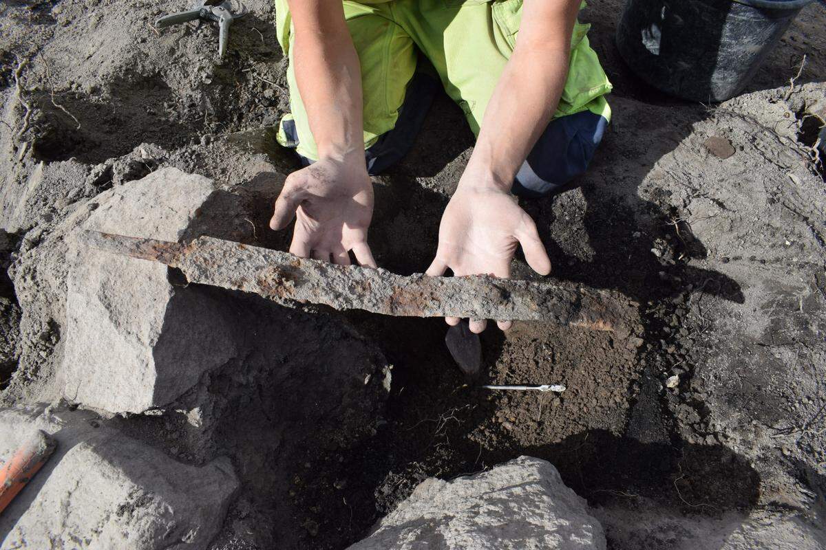 One of the swords fully removed from the stone grave.