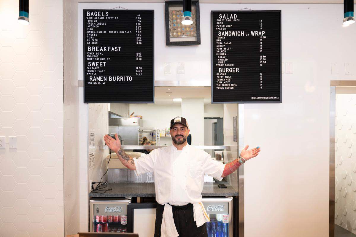Josh Marcus of Josh’s Deli shows off his menu at Josh’s Corner Diner at Central Fare.