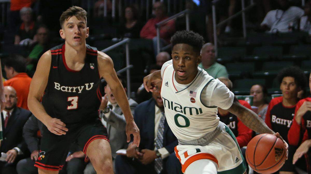 Miami Hurricanes guard Chris Lykes (0) drives against Barry University Buccaneers guard David Moya (3) during the first half of an NCAA college basketball exhibition game at the Watsco Center in Coral Gables on on Tuesday, October 30, 2018.