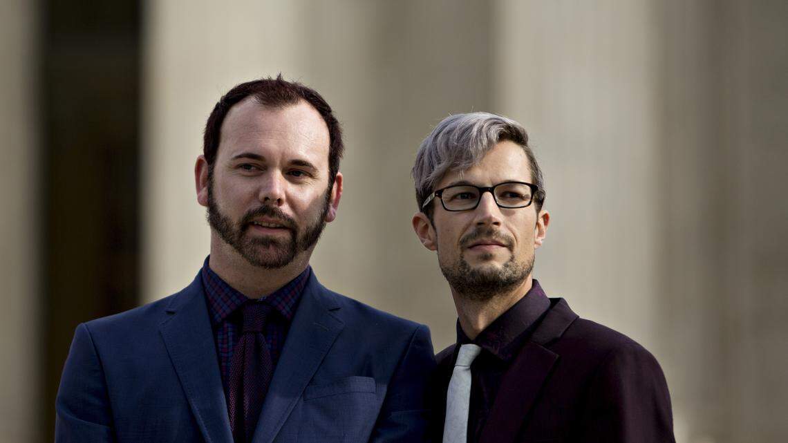 David Mullins, left, and husband Charlie Craig, shown in Washington in December 2017, filed a civil rights complaint to the Colorado Civil Rights Commission after Masterpiece Cake shop owner Jack Phillips refused to make cakes for same-sex weddings. On Monday, the Supreme Court ruled 7-2 in favor of the cake baker.