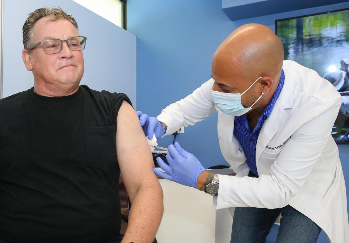Duane Rinde, 57, an Oakland Park resident, receives the monkeypox vaccine administered by nurse practitioner Joel Ramos at Latinos Salud in Wilton Manors, Florida, on Wednesday, July 20, 2022. He also received the meningococcal disease vaccine after hearing about a friend in Texas who contracted the illness and lost his hands and feet.