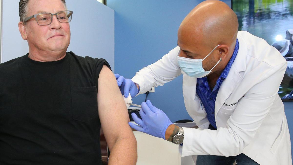Duane Rinde, 57, an Oakland Park resident, receives the monkeypox vaccine administered by nurse practitioner Joel Ramos at Latinos Salud in Wilton Manors, Florida, on Wednesday, July 20, 2022. He also received the meningococcal disease vaccine after hearing about a friend in Texas who contracted the illness.