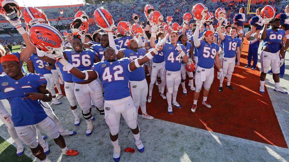 Florida players celebrate in front of fans after defeating Idaho in an NCAA college football game, Saturday, Nov. 17, 2018, in Gainesville, Fla.