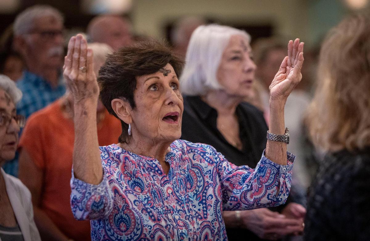 Patty Marma prays during Ash Wednesday mass at St. Anthony Church in Fort Lauderdale, where Archbishop Thomas Wenski celebrated mass.