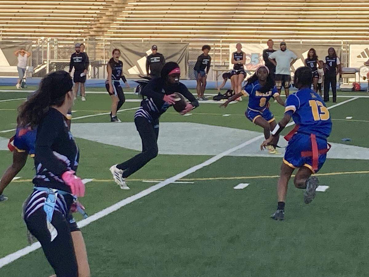 Palmetto’s Takaylah Strowbridge avoids Northwestern defenders during Monday’s GMAC flag football championship game at Traz Powell Stadium,